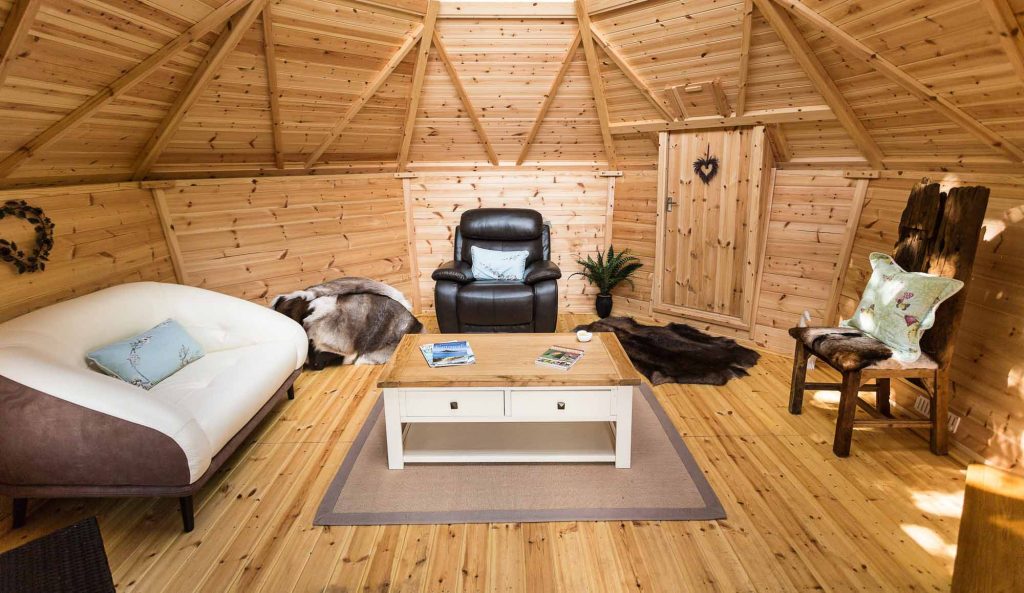 barbecue hut with sofa and arm chair inside it