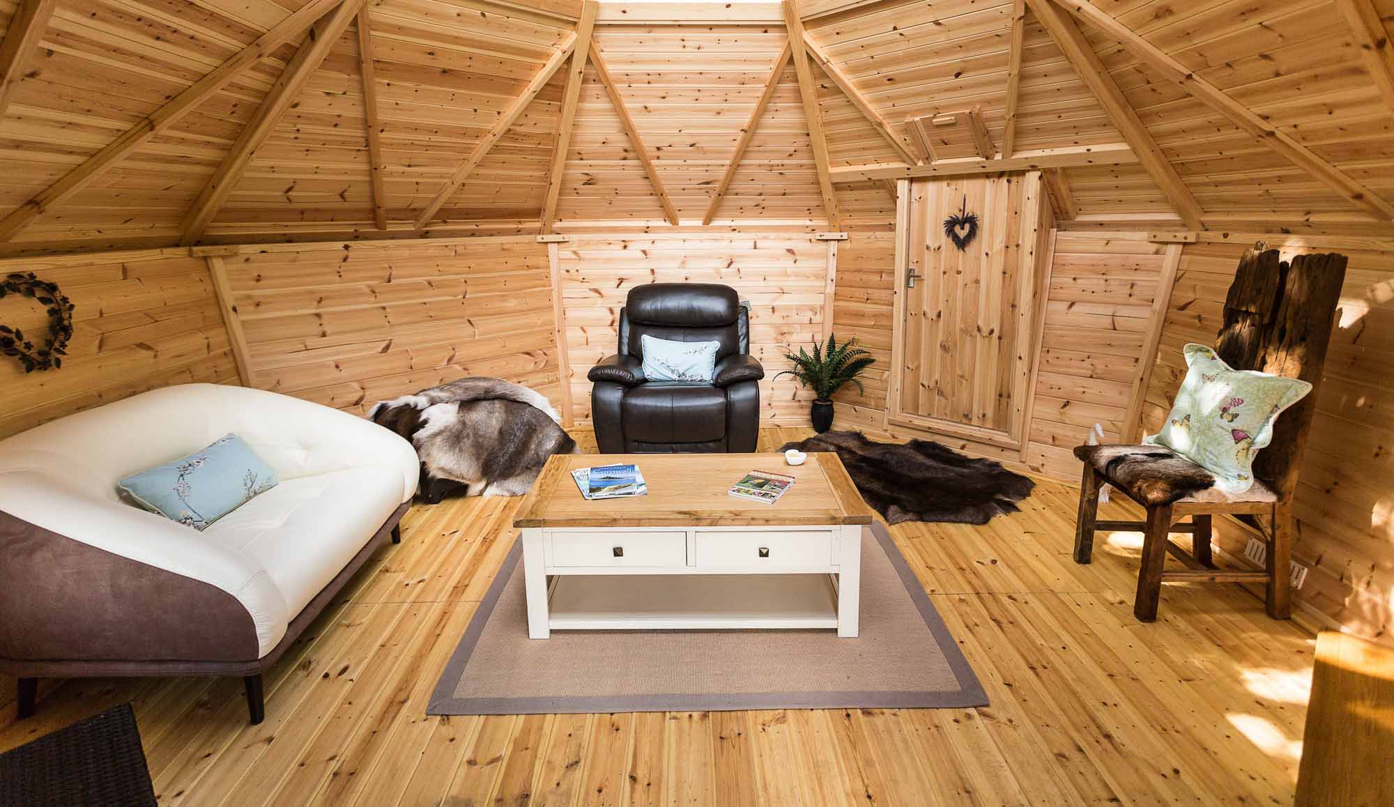 barbecue hut with sofa and arm chair inside it
