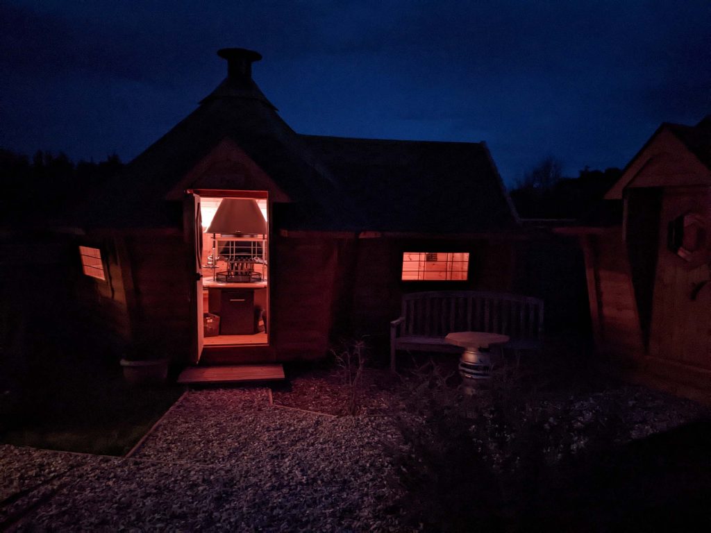 fox bar bbq hut in dark with lights on inside