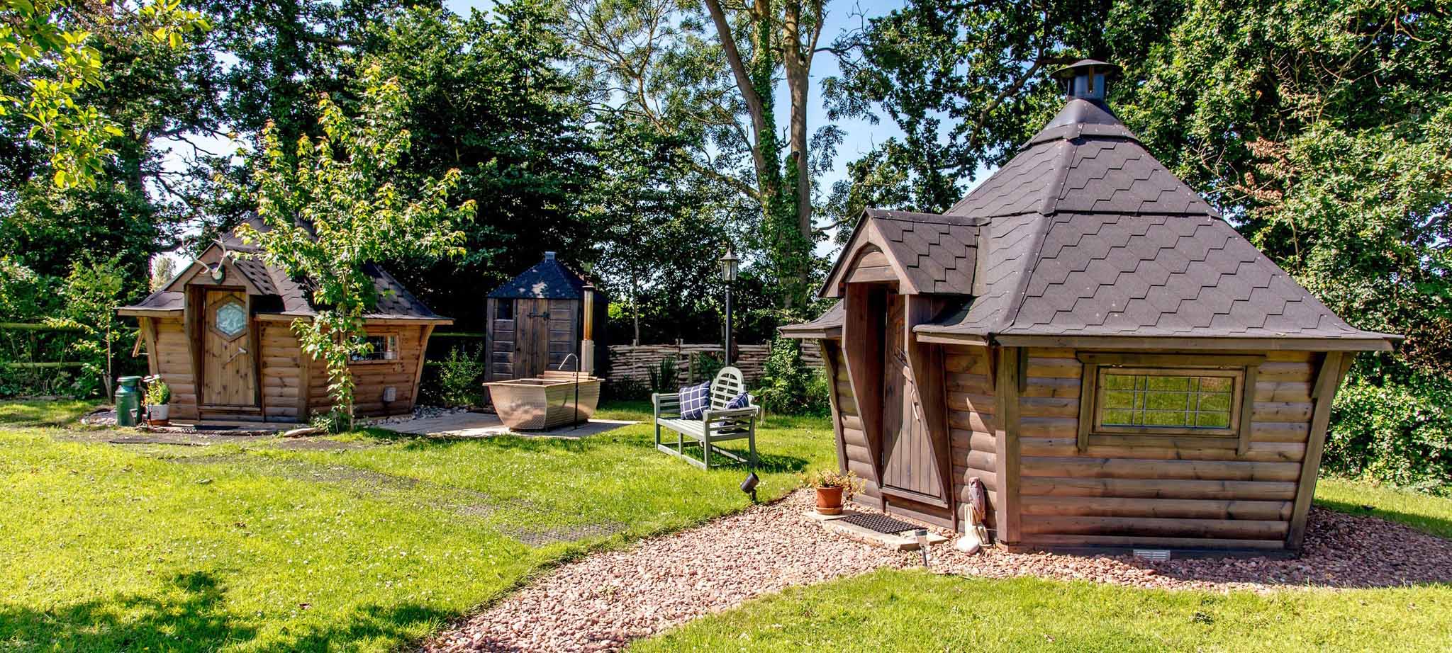two bbq cabins at glamping site with outside bath