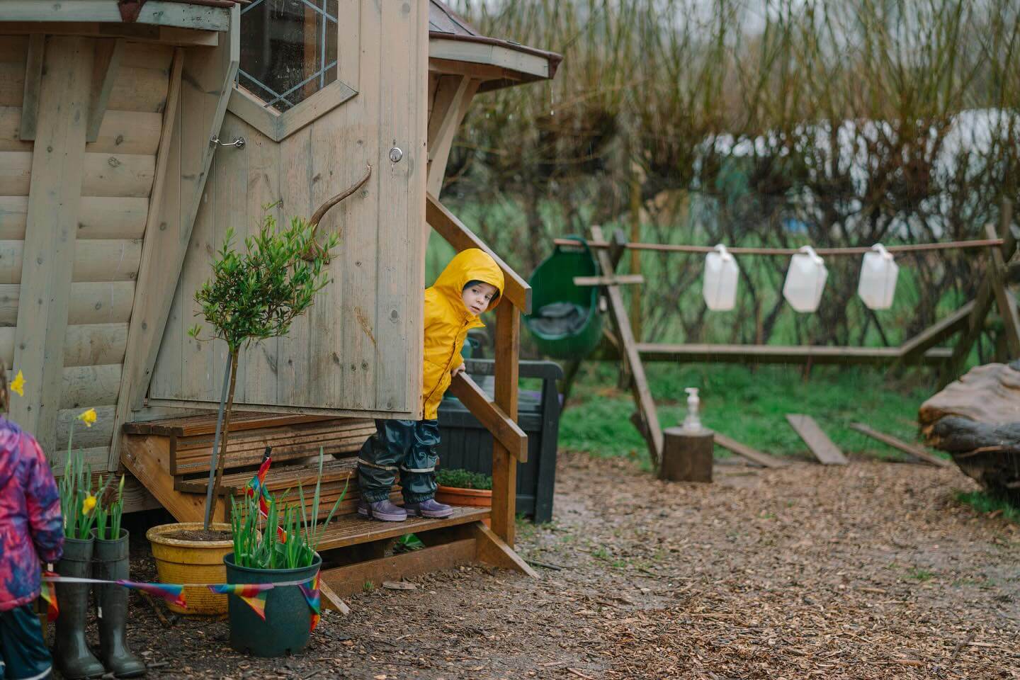 toddler peeking out of bbq cabin