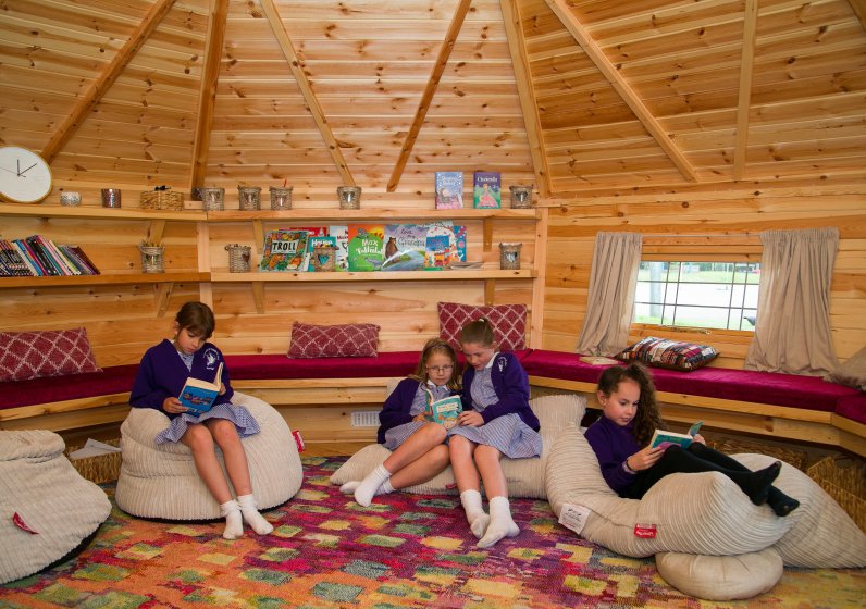 school children reading inside a BBQ Lodge school room