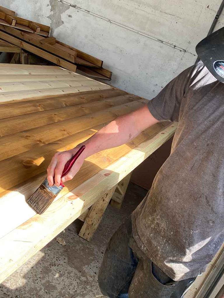 bbq lodge panels being stained