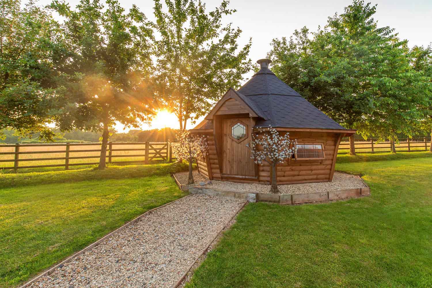 barbecue cabin with sun setting behind it