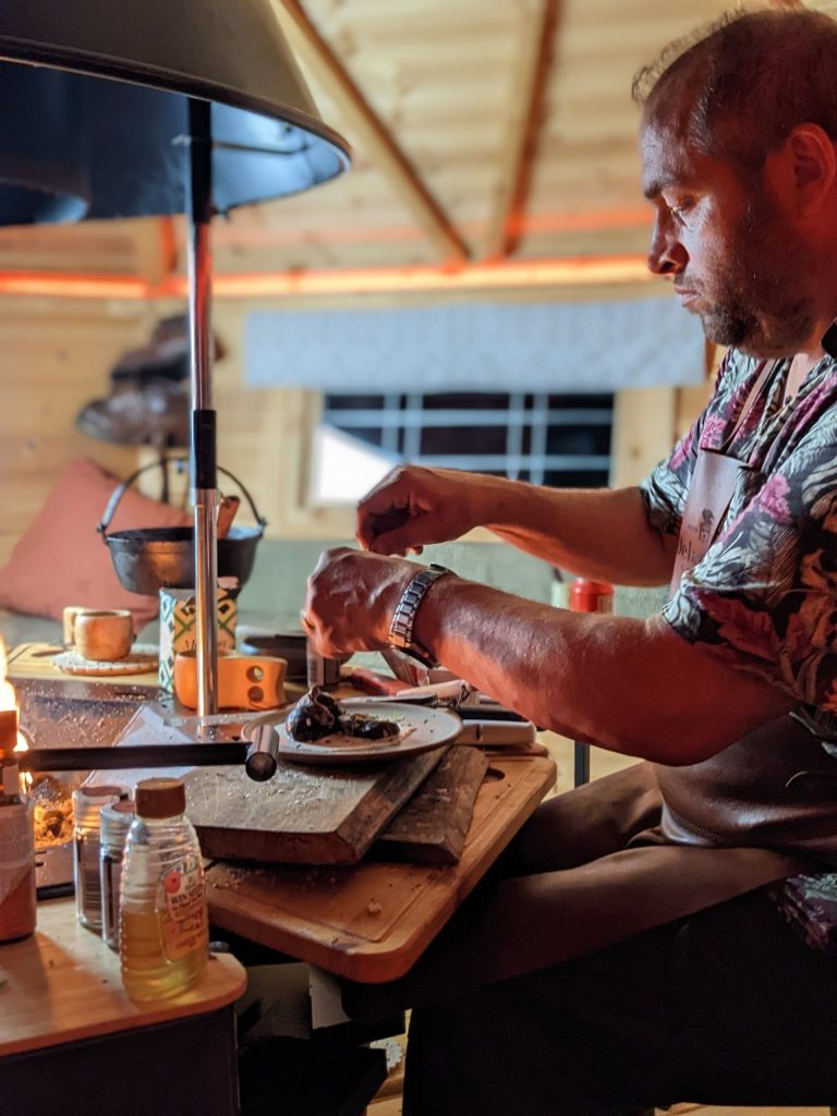 marucs bawden cooking in a bbq hut